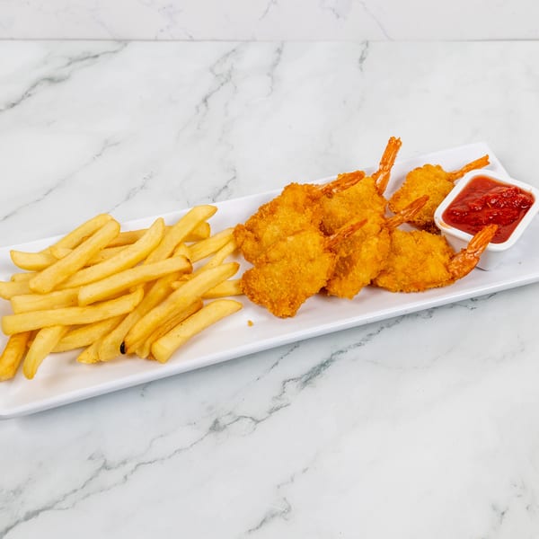Crispy fried shrimp and golden french fries on a white rectangular plate with a side of ketchup.