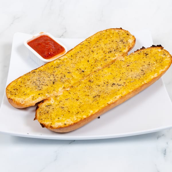 Two golden-brown garlic bread halves with herbs, served on a white plate with a side of marinara sauce.