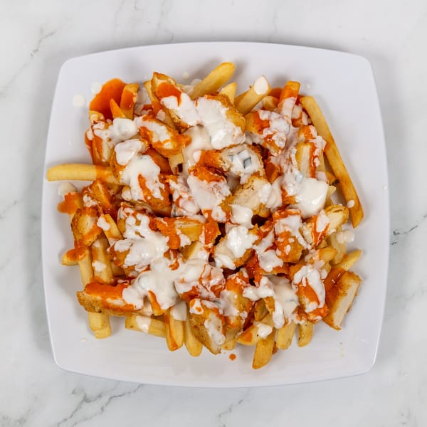 Crispy french fries topped with buffalo chicken pieces, drizzled with ranch dressing.